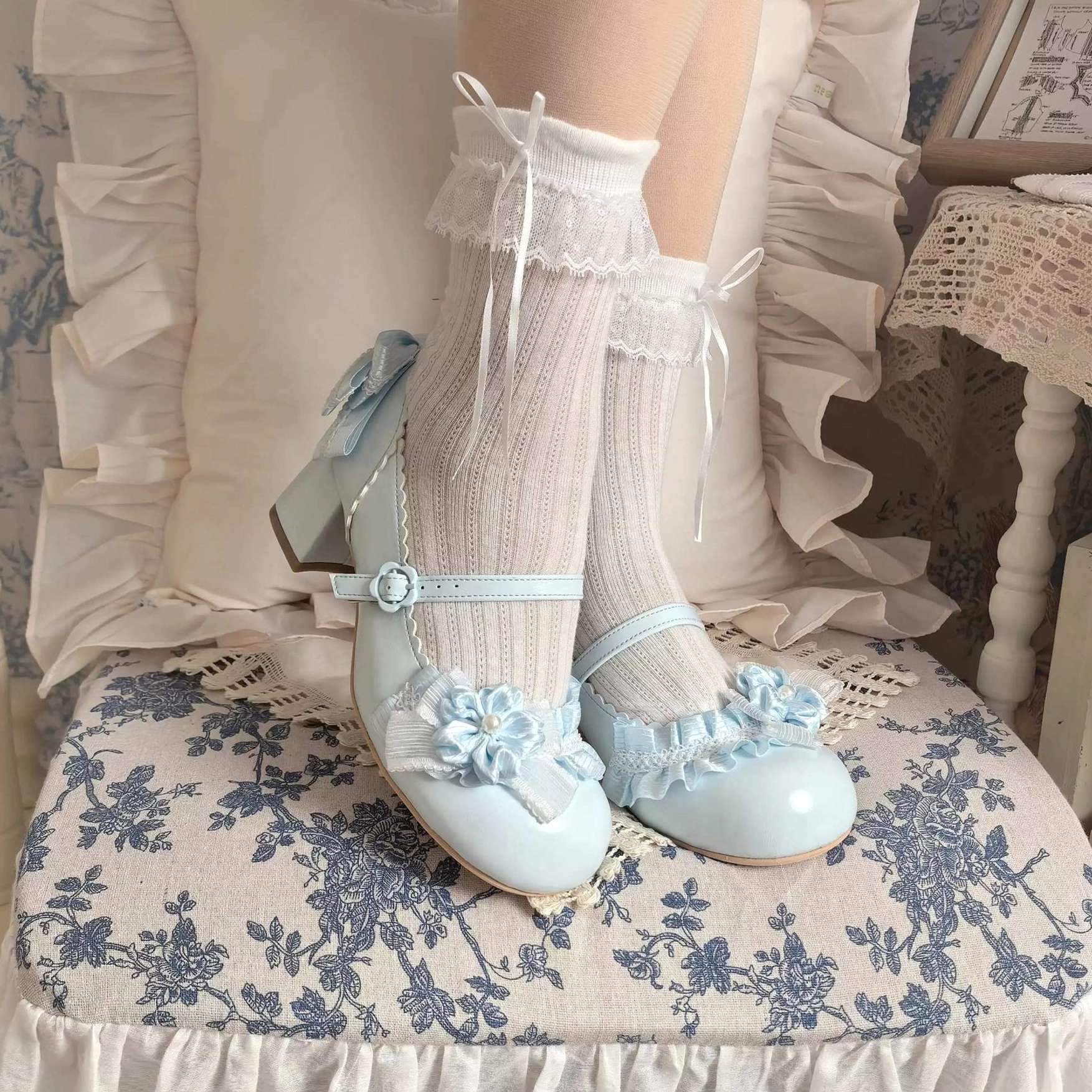 light blue sweet lolita mary jane heel shoes on model feet lower leg ruffled lace socks floral applique ankle strap bow