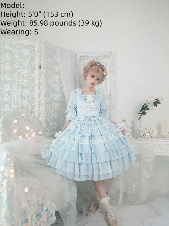 Light blue Sweet Lolita OP dress with short tiered ruffle skirt and floral neck decoration on model size S, height 153cm, front flat studio view