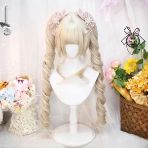 Light gold blonde detachable twin curly ponytail Lolita wig with soft spiral curls and blunt bangs, styled with pink bow hair accessories on pastel flower backdrop