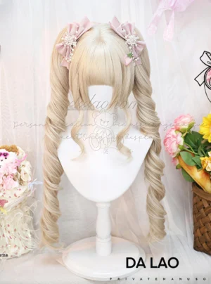 Light Golden blonde Lolita Roman roll twin tails daily wig front full view on display head, featuring neat blunt bangs, curly detachable ponytails, and matching pink flower bow clips with floral backdrop