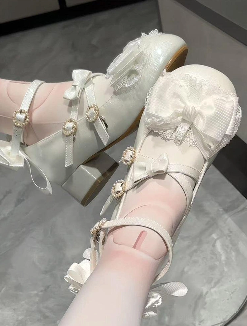 Milky light gray Lolita Mary Jane shoes first-person on-foot side view with white stockings marble floor background sheer lace trim multiple adjustable straps ruffled detachable back bow