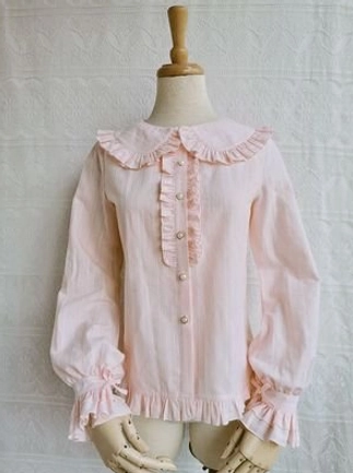 Light pink cotton Lolita blouse with Peter Pan ruffled collar front ruffled trim pearl buttons soft pink color ruffled cuffs hem on wooden mannequin