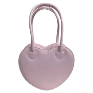 Light pink heart-shaped Lolita handbag featuring smooth faux leather surface and small heart decorations on top, flat lay view