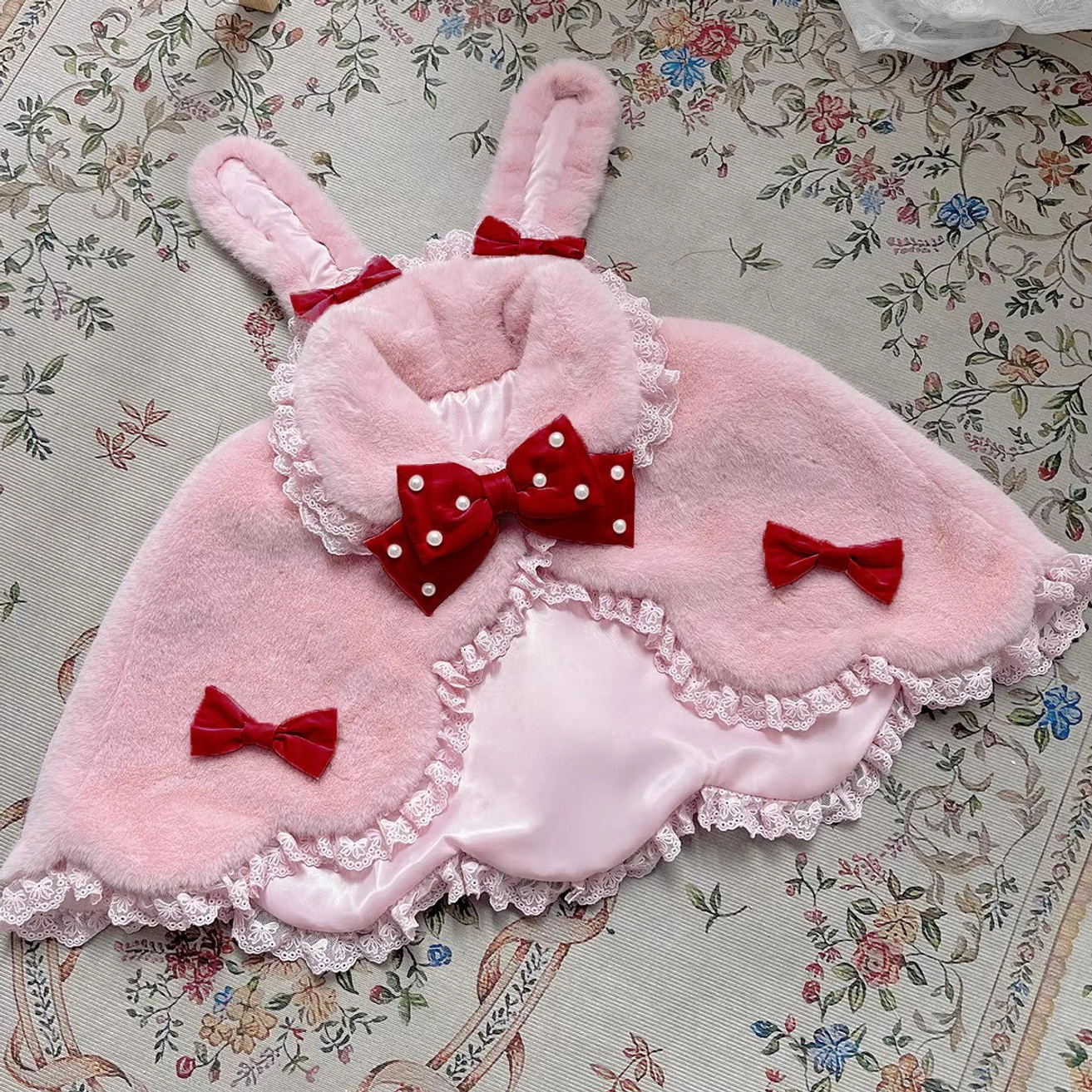 Light pink Lolita cape with red pearl bow and rabbit ears winter plush fashion flat lay presentation