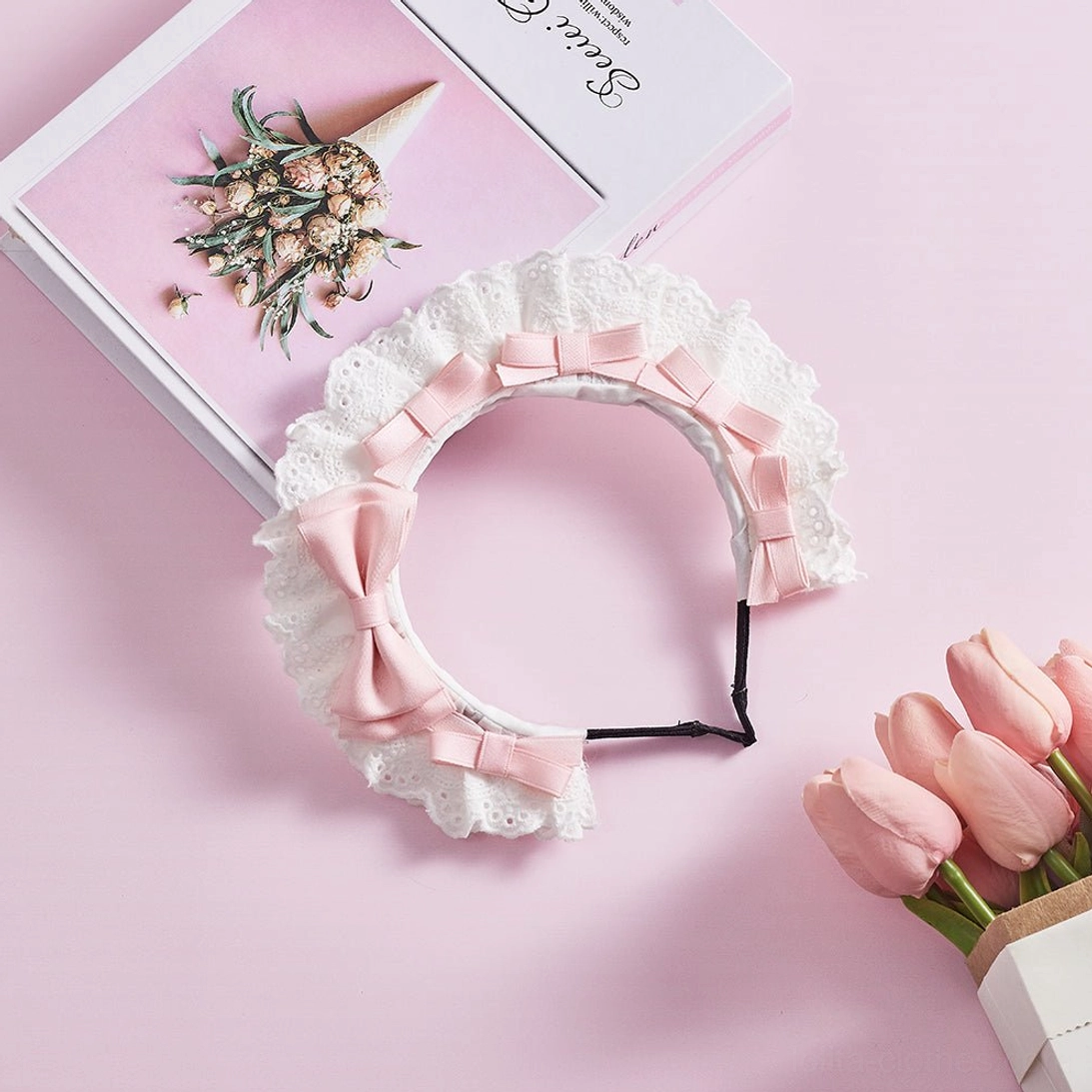 Light pink lolita lace KC headband flat lay arrangement featuring romantic satin bows and elegant white ruffled lace edge for sweet lolita fashion