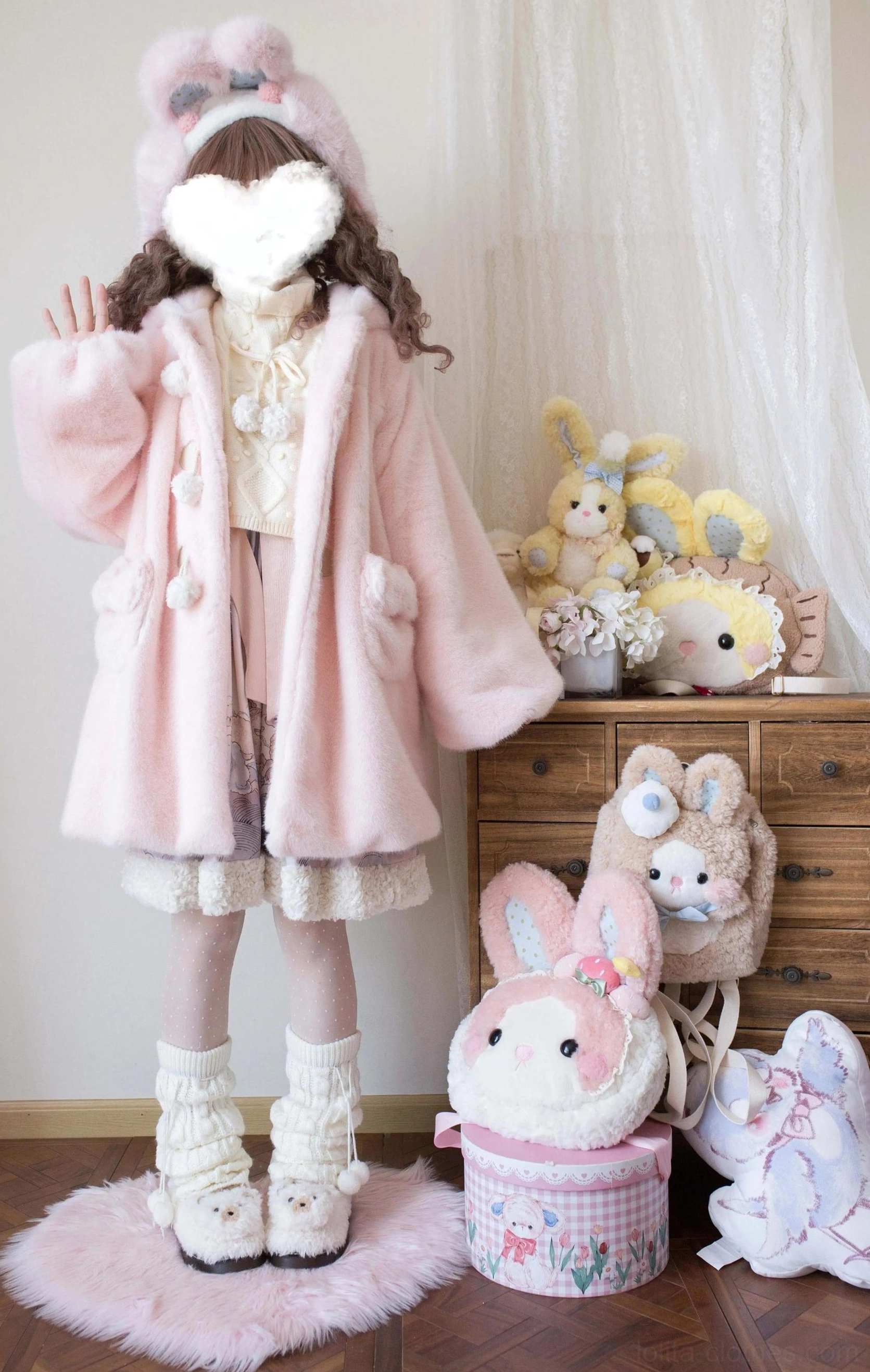 Light pink lolita winter thickened fleece overcoat with bear ear hood, pom-pom toggle buttons and ruffled hem, full-body front standing in plush studio