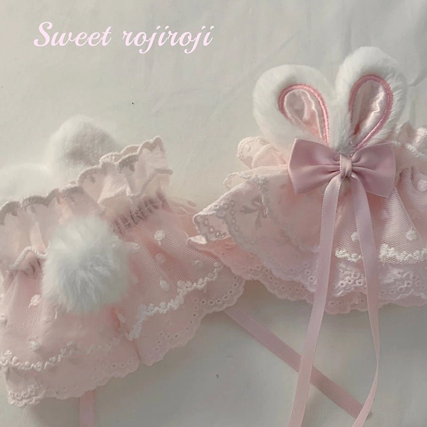 Light pink rabbit ear lace wrist cuffs fur pom-pom plush bunny ears polka dot lace satin bow ultra close-up