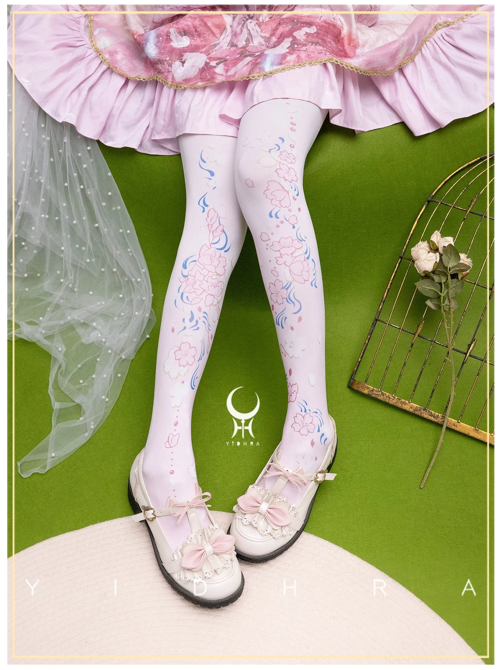 Light pink sakura print Lolita pantyhose 120D with blue vine and pink cherry blossom complete leg coverage brand logo detail paired with pink frilly skirt