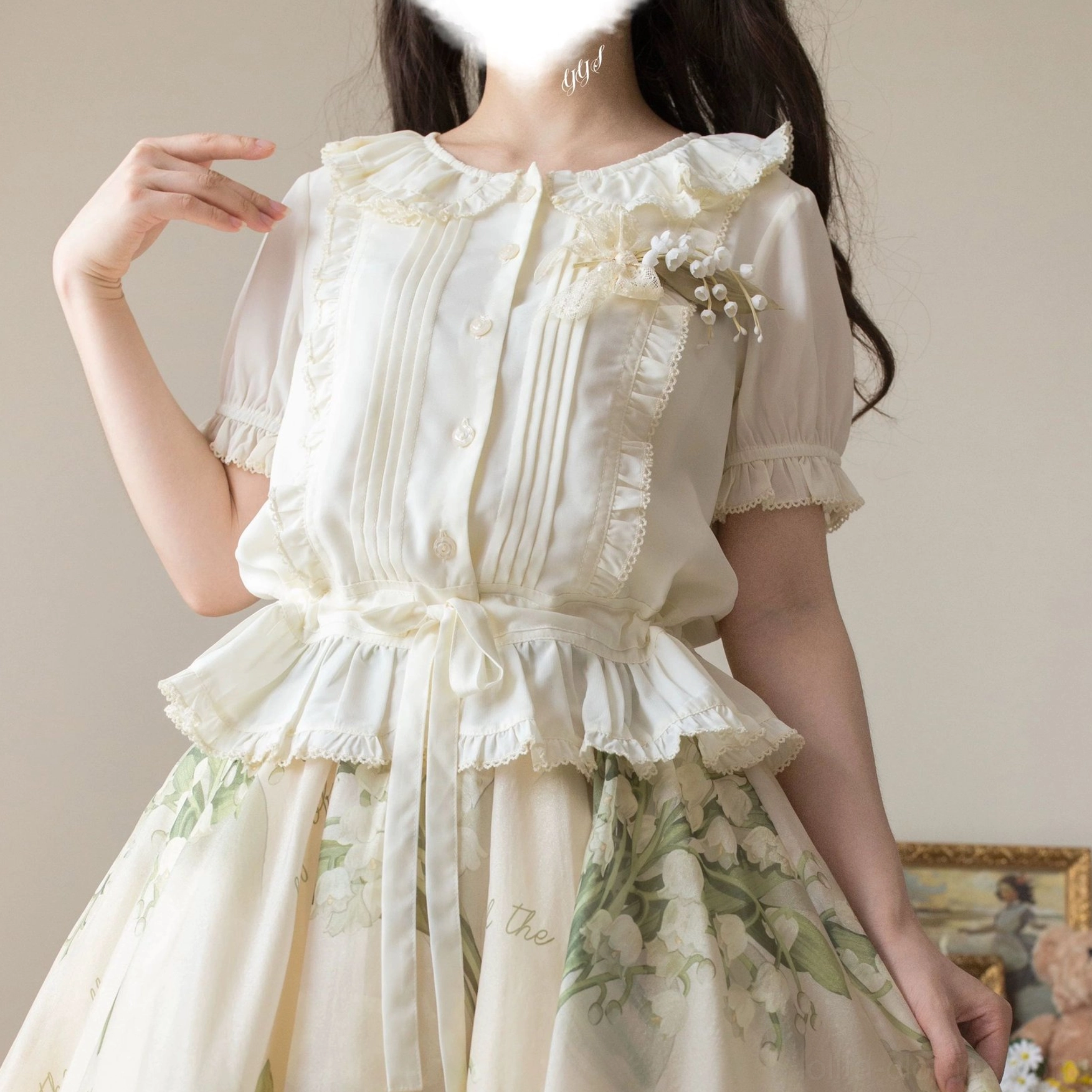 Light pink Tencel semi-sheer sweet Lolita blouse showing waist bow decoration, ruffled collar, short puff sleeves with elastic cuffs, and front button details