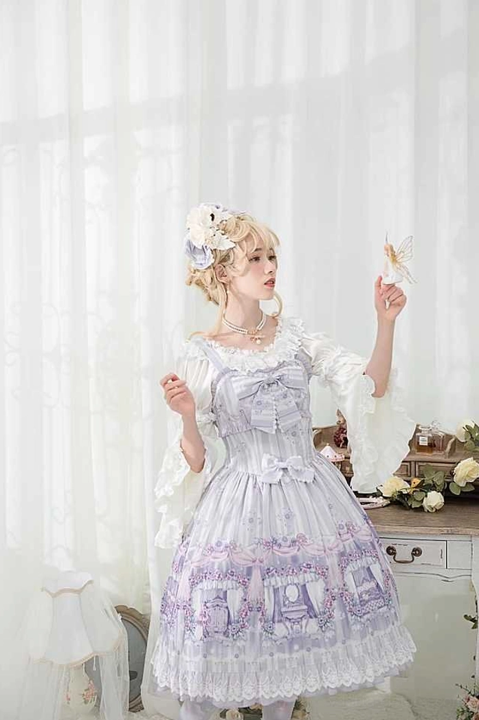 Lolita fashion model in light purple ruffled gown with white collar and floral print wearing pearl bow necklace, side half-body portrait shot in bright vanity studio, floral hair ornament accessory, elegant pose