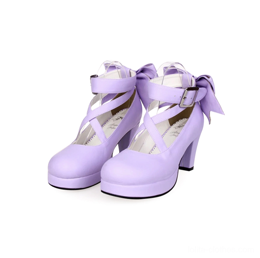 Light purple matte Lolita platform high heel shoes featuring crossover ankle straps with buckle detail, small back bow, round platform toe, and chunky block heel - front three-quarter view