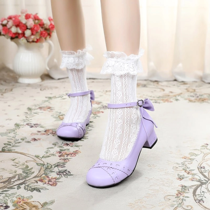 Light purple sweet lolita Mary Jane round toe flat shoes with ankle buckle strap and rear bow detail on model wearing ruffled lace ankle socks, displayed on vintage floral carpet background