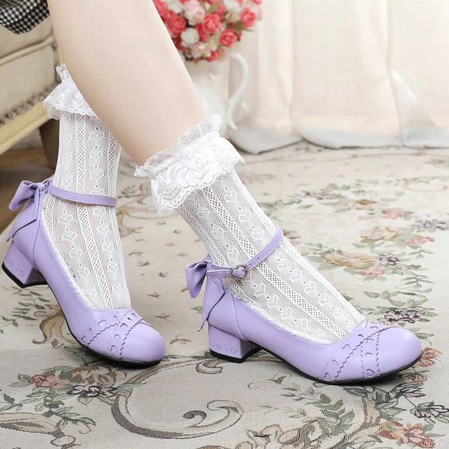Front overhead view of light purple sweet lolita Mary Jane round toe flat shoes on both model feet showing pair wearing with ruffled lace ankle socks and stitched vamp details