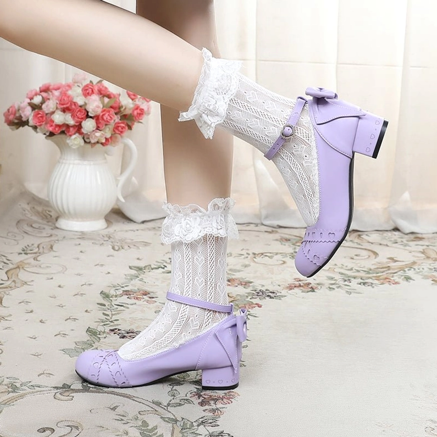 Side profile close-up of light purple sweet lolita Mary Jane round toe flat shoes showing ankle strap with rear bow and low block heel on model with ruffled lace ankle socks