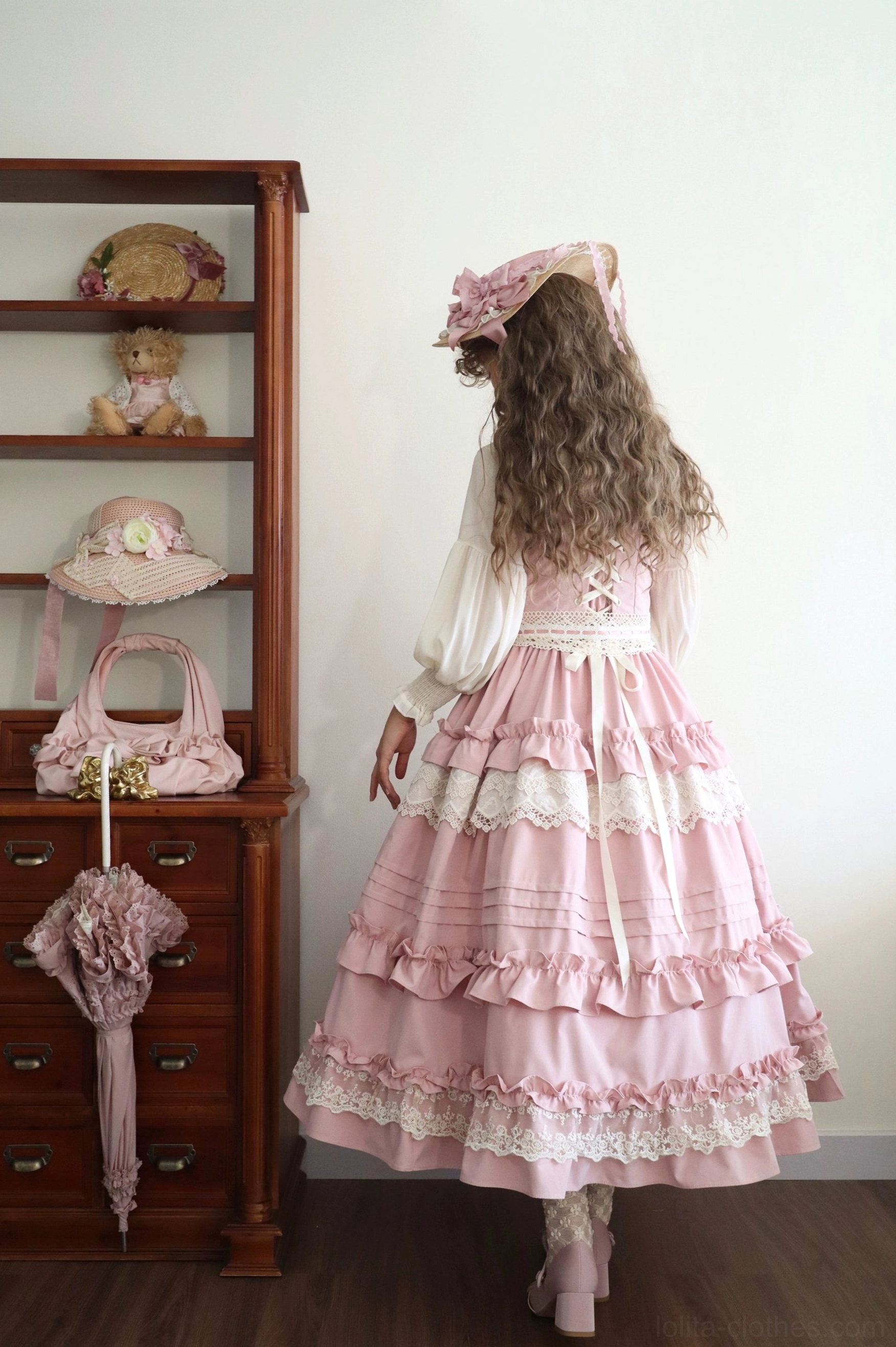 Lilianne pink lolita jsk dress back view tiered ruffled lace hem waist bow sash long curly hair vintage accessories