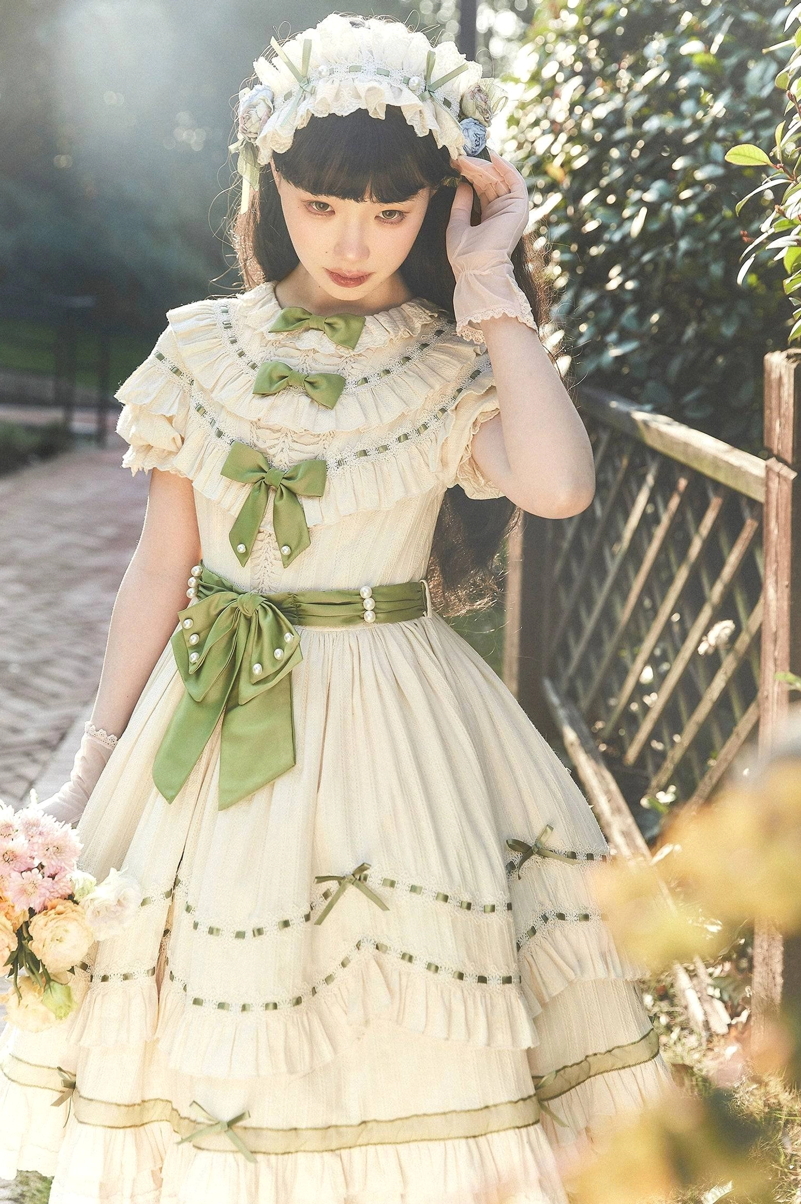 Lily of the valley country lolita OP dress with cream fabric, sage green accents, tiered ruffle construction, and Peter Pan ruffled collar detail shot