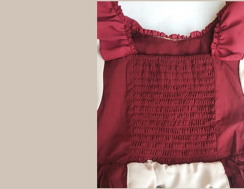 Little Red Riding Hood pastoral Lolita OP dress and hooded cloak fullset detail view emphasizing crossover straps, tiered ruffles, and color blocking between wine red ice silk and cream fabric sections