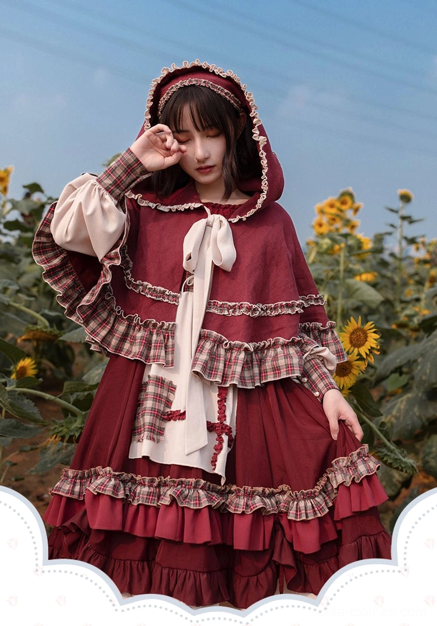 Dynamic front spinning view of Little Red Riding Hood pastoral Lolita OP dress with headscarf, tiered ruffles, plaid fabric accents, and cream-colored gingham picnic basket in outdoor grassland