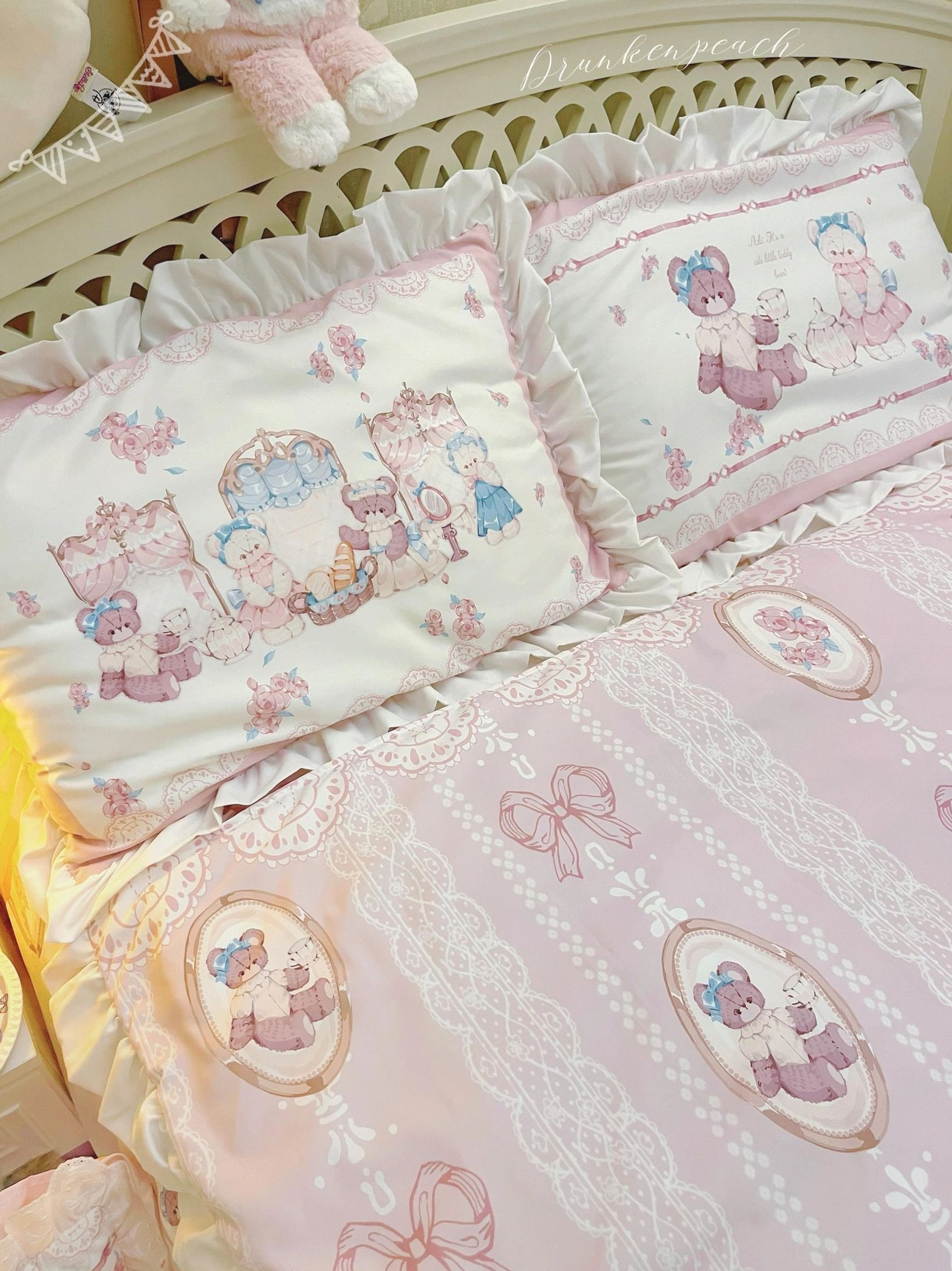 Close-up side view of lolita bedding set details featuring ruffled pillow shams with bear tea art prints, lace-patterned bed fabric, and coordinated circular bear medallion motifs