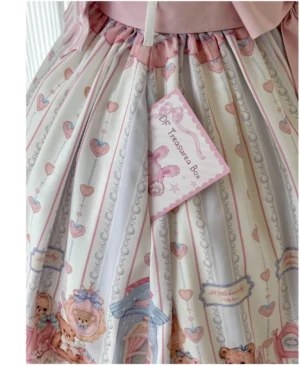 Close-up detail of lolita dress waist showing pink ruffled overlay stripe pattern with teddy bear heart print and lace accents