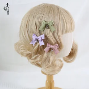 Sweet lolita bell bow hair clips styled on mannequin head with blonde curly wig, featuring matcha green, light purple and baby pink clips in back hairstyle view