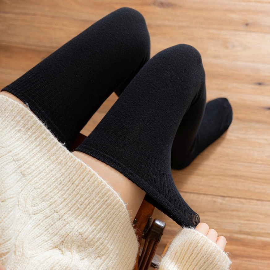 Black lolita cotton knee stockings close-up overhead leg view ribbed cuff snug fit cream sweater