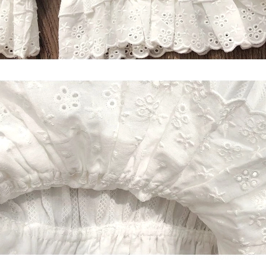 Extreme close-up of exquisite hollow embroidery lace ruffled hem pattern on premium lolita cotton bloomers, displaying delicate wavy ruffled scalloped edge texture, intricate floral cutout embroidery detail, and soft breathable premium cotton fabric composition
