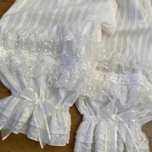 Close-up detailed view of polka dot tulle lace trim and satin ribbon bow on Lolita bloomers, showing intricate multi-layered ruffled lace cuff construction and scalloped edging