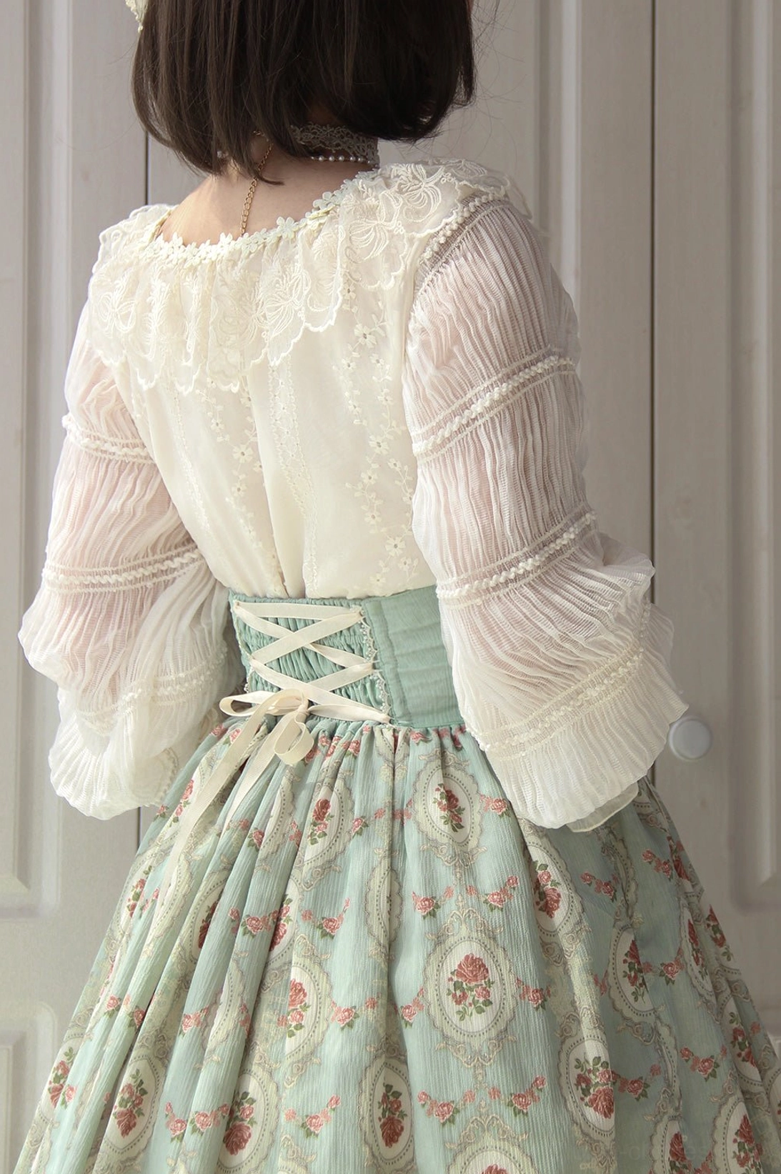 Back view of vintage Lolita blouse showing lace yoke design and long lantern sleeves with ruffled cuffs