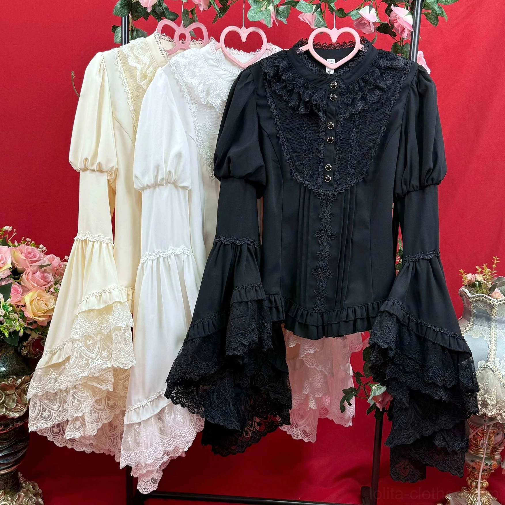 Collection display of Lolita blouses showing multiple color options black and cream off-white with layered lace trumpet sleeves hanging flat