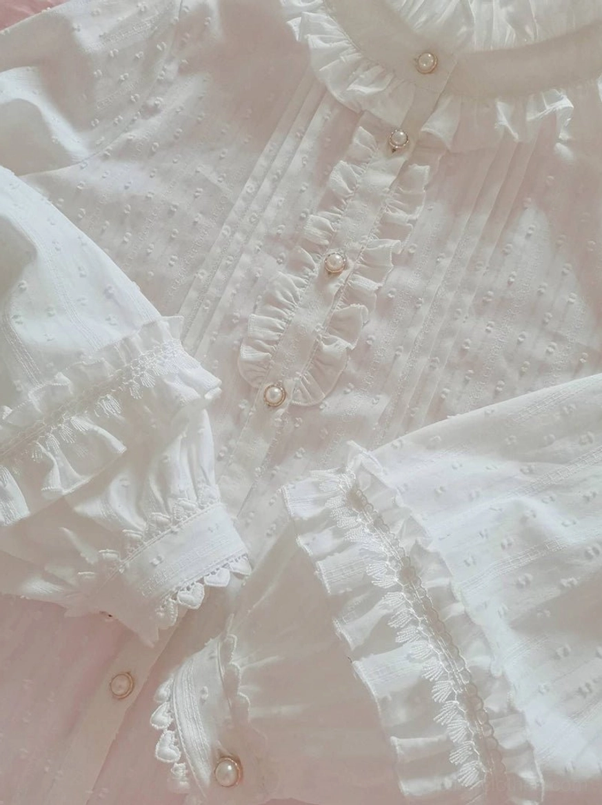 Extreme close-up lolita blouse front pearl button row ruffled pleated placket ruffled cuffs lace trim dotted texture