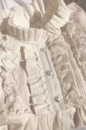 lolita blouse close-up front placket pearl buttons ruffled collar lace trim details off-white cotton