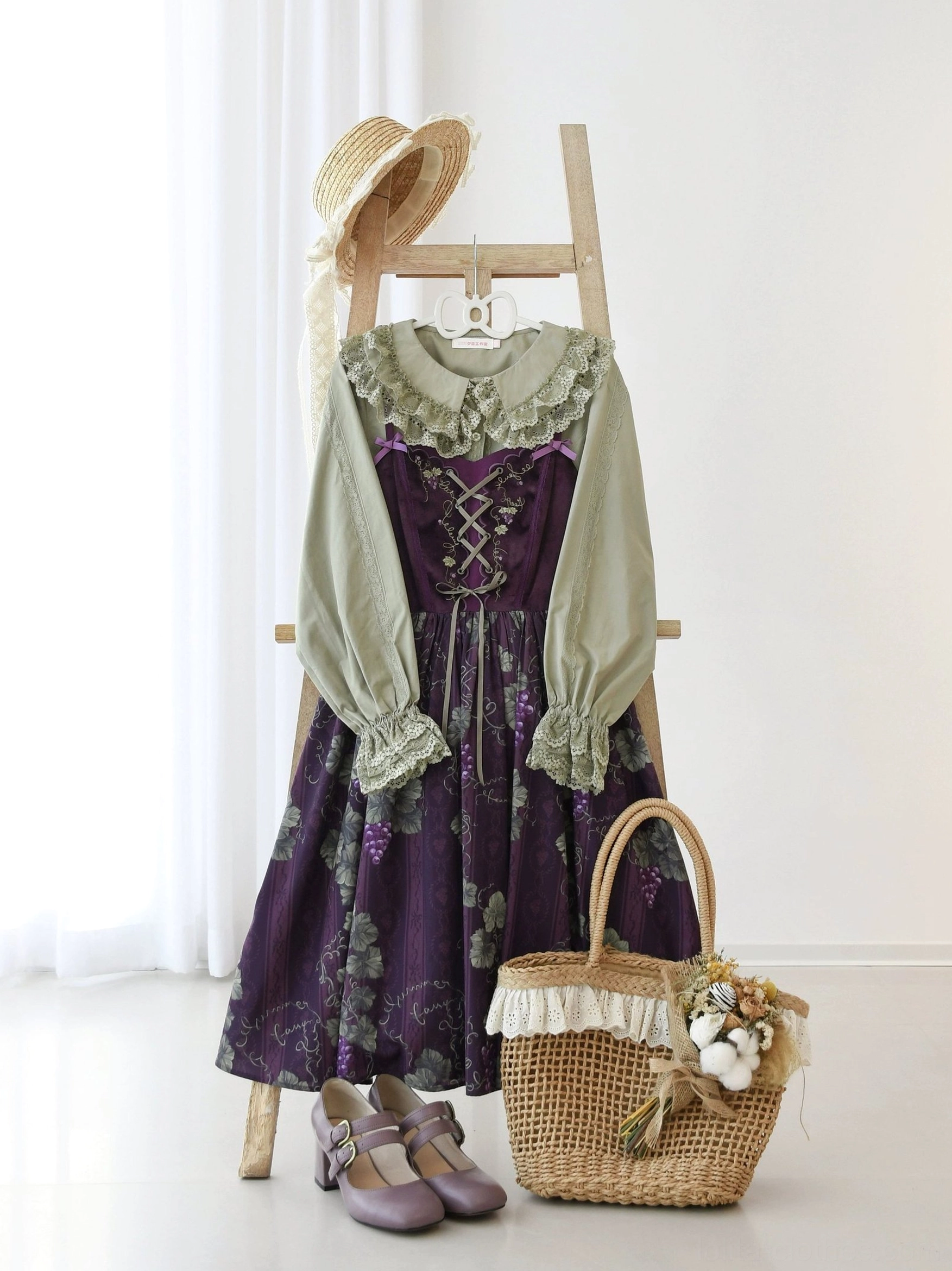 Full body mannequin display of daily Lolita coordinate featuring white blouse with vintage town print JSK dress, styled with wooden ladder prop, straw hat, wicker basket, and leather shoes for vintage rural aesthetic