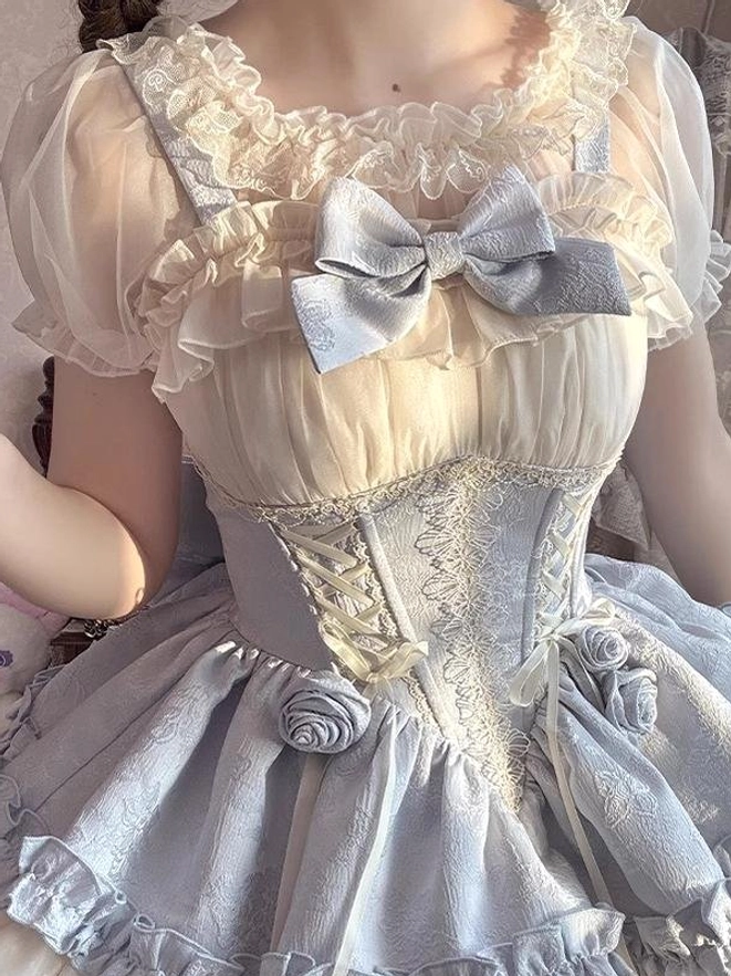 Off-shoulder Lolita blouse close-up showing sheer ruffled trim silver bow knot and ruched mesh chest detail paired with rose-adorned corset skirt