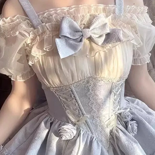 Off-shoulder Lolita blouse with sheer ruffled collar and silver bow paired with coordinated corset dress set worn by model showing styling versatility