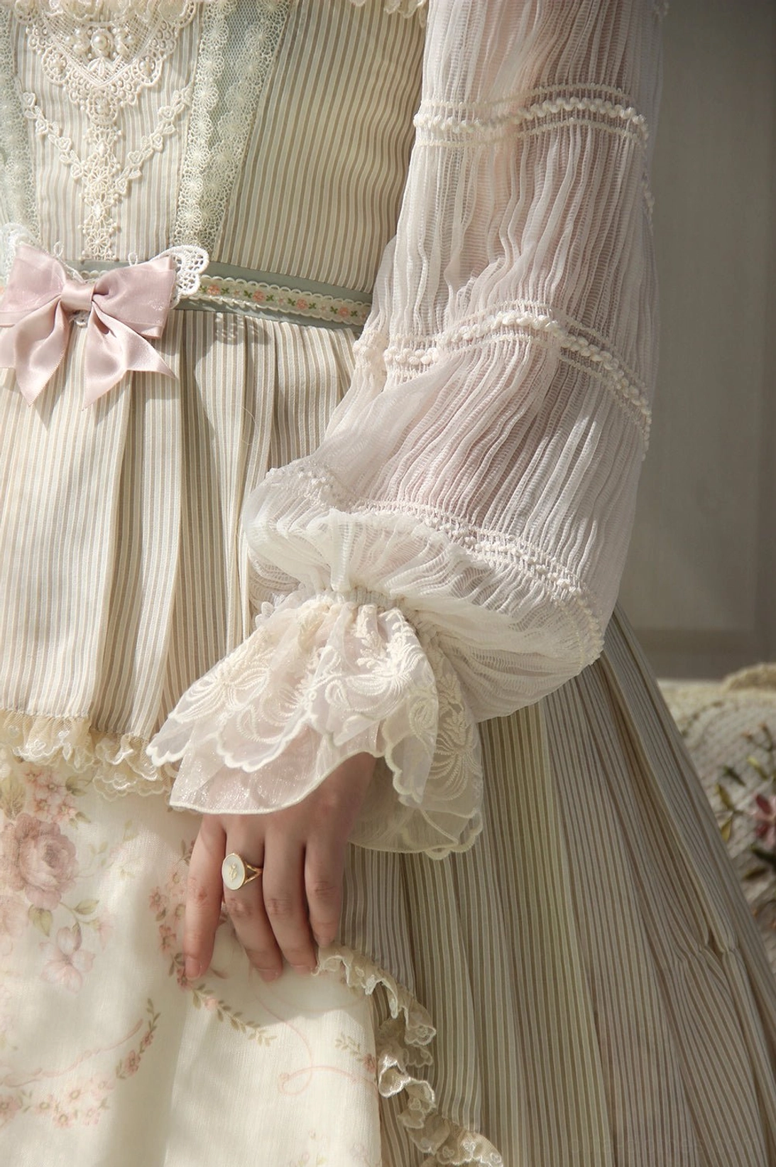 Side detail of chiffon Lolita blouse showing pleated sheer ruffle sleeves with lace trim and waist decoration
