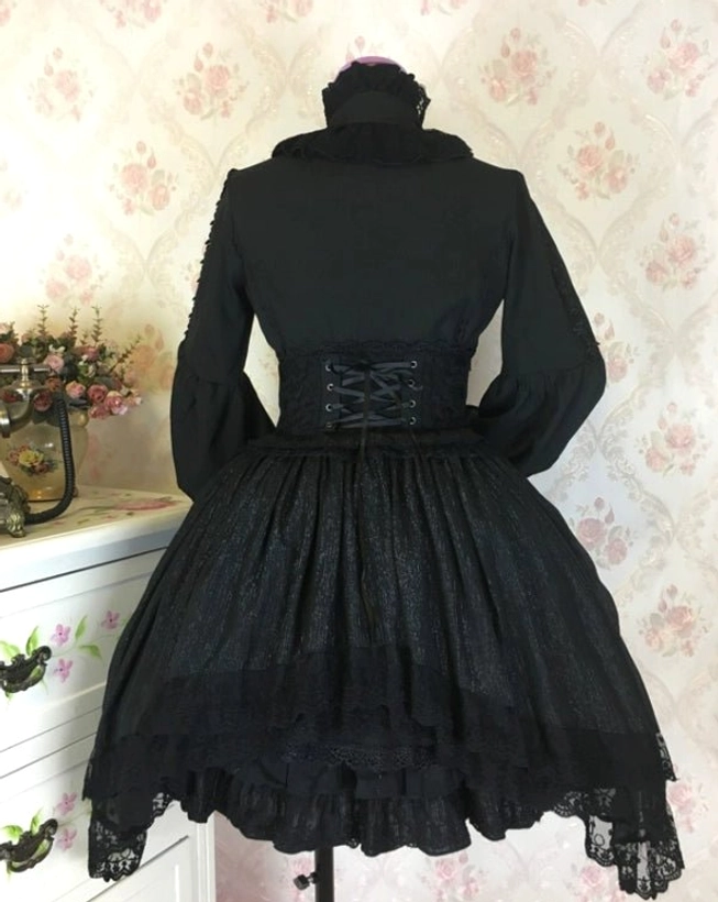 Styled fashion photography of classic Lolita blouse worn in romantic coordinate with complementary skirt, accessories, and shoes for complete Lolita fashion outfit inspiration