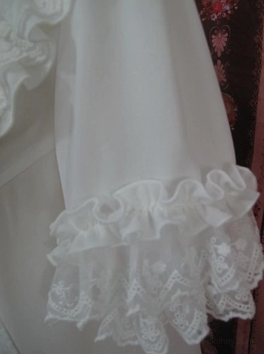 Close-up shot of sleeve cuff showing double-layer ruffled cuffs with embroidered lace outer trim and soft chiffon fabric