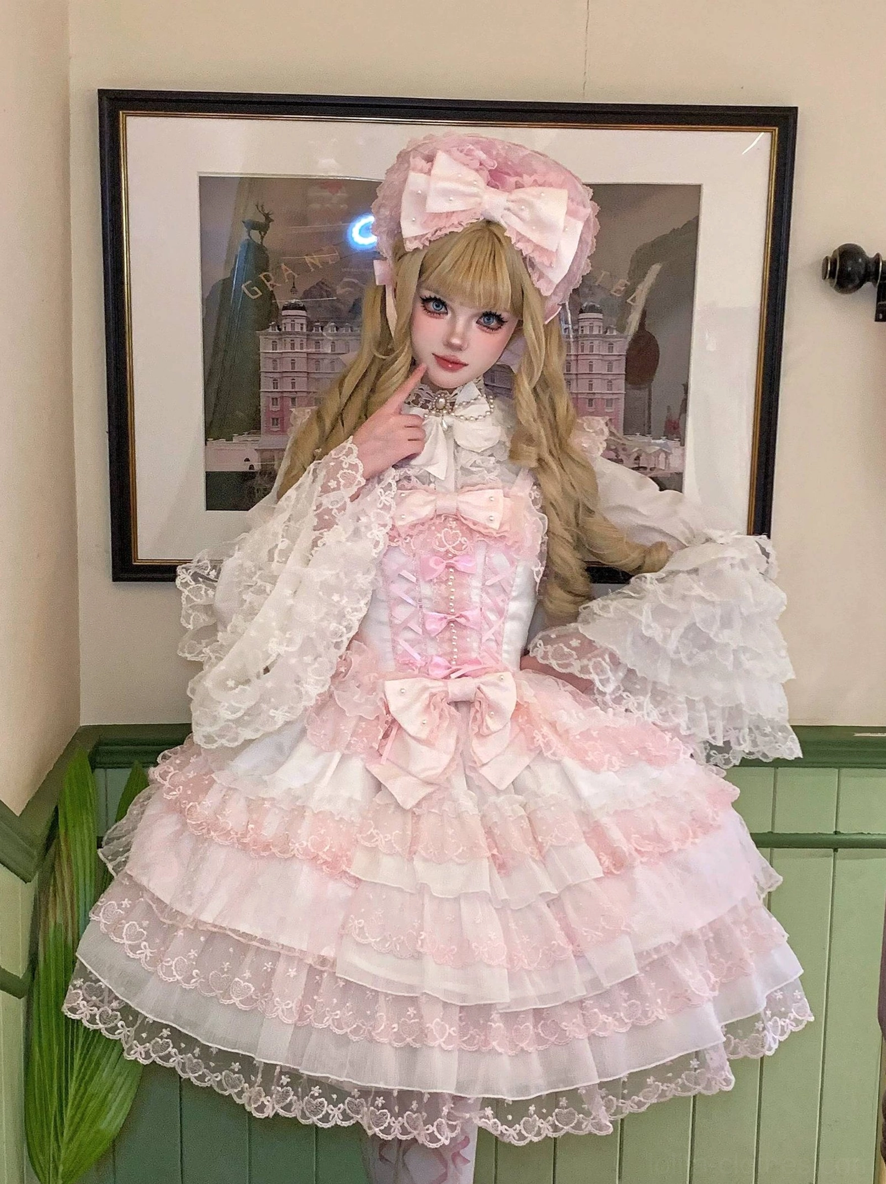Three-quarter view of Sweet Lolita blouse showing puffy lace sleeves, corset bodice, layered tulle skirt with lace trim, and decorative bow details from side angle