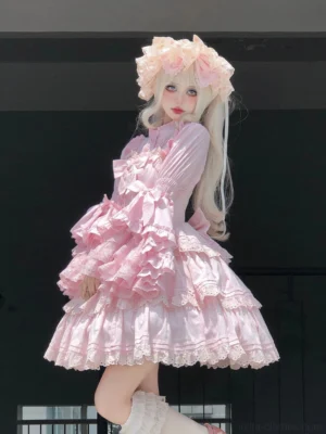 Pink ruffled tiered lolita dress with fitted waist multi-layered lace ruffles and flared cuffs side three-quarter view