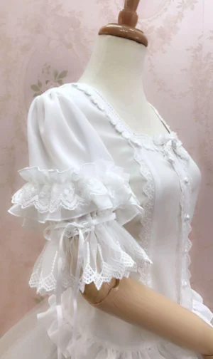 White lace lolita blouse three-quarter side view showing tiered ruffled sleeves with ribbon ties and layered construction detail