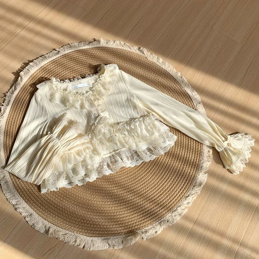 Three-piece lolita coordinate styling featuring black bolero with beige jumperskirt showing complete layered ensemble with lace accents