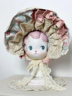 Classic lolita bonnet front flat display with beige lace ruffle dusty pink satin bow floral printed inner lining long lace neck ties ceramic head form