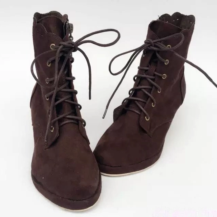 Direct frontal view of paired vintage Lolita high-heel suede boots with metal eyelet lace-up closure, chunky block heel, and dark brown suede construction