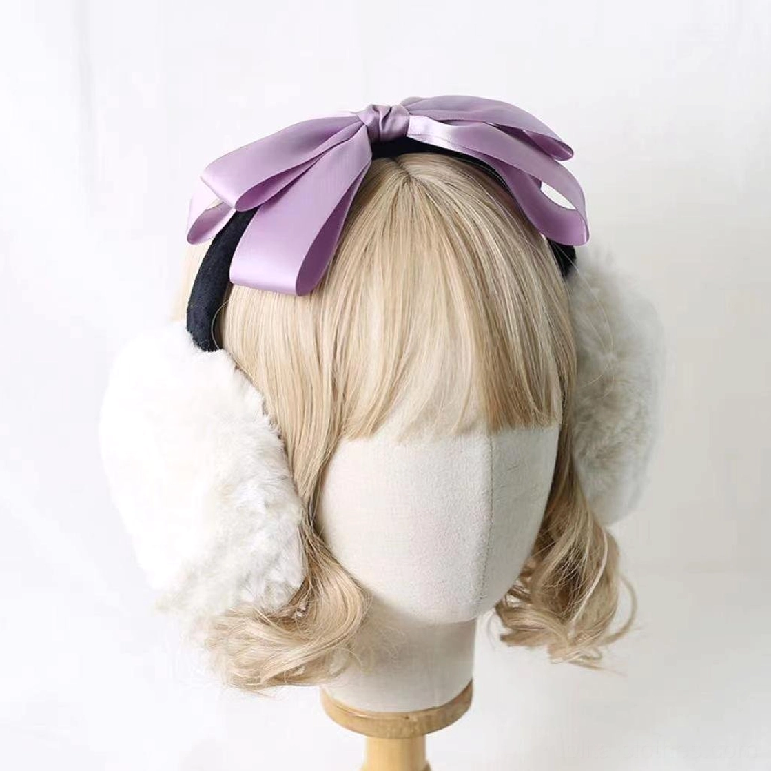 Lolita bow earmuff headdress on mannequin featuring light purple taro satin bow, white fluffy earmuff design with black headband, classic lolita style