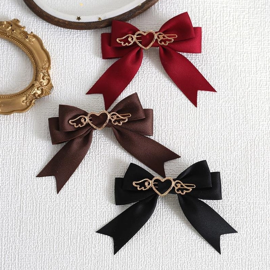 Assorted lolita bow hair clips in wine red burgundy dark brown and black with gold heart-wing ornaments