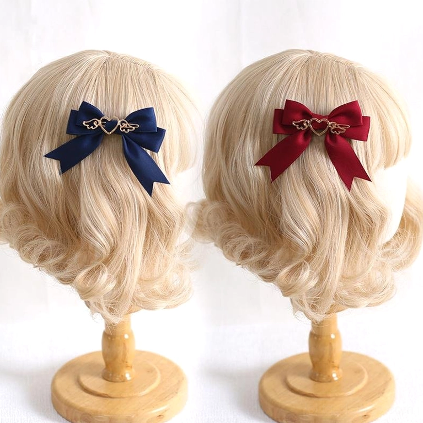 Navy blue and wine red burgundy lolita bow hair clips on wig stands showing color options and heart-wing detail