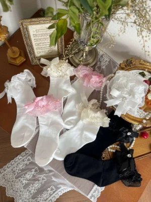 assorted sweet lolita short socks collection flat lay display multiple colors pink white black with ruffled lace cuffs rhinestone bow embellishments