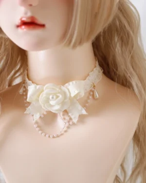 Romantic camellia bow choker with cream roses and teardrop pearl pendant on mannequin, version B wooden ear edge, front three-quarter view of delicate layered pearl chains