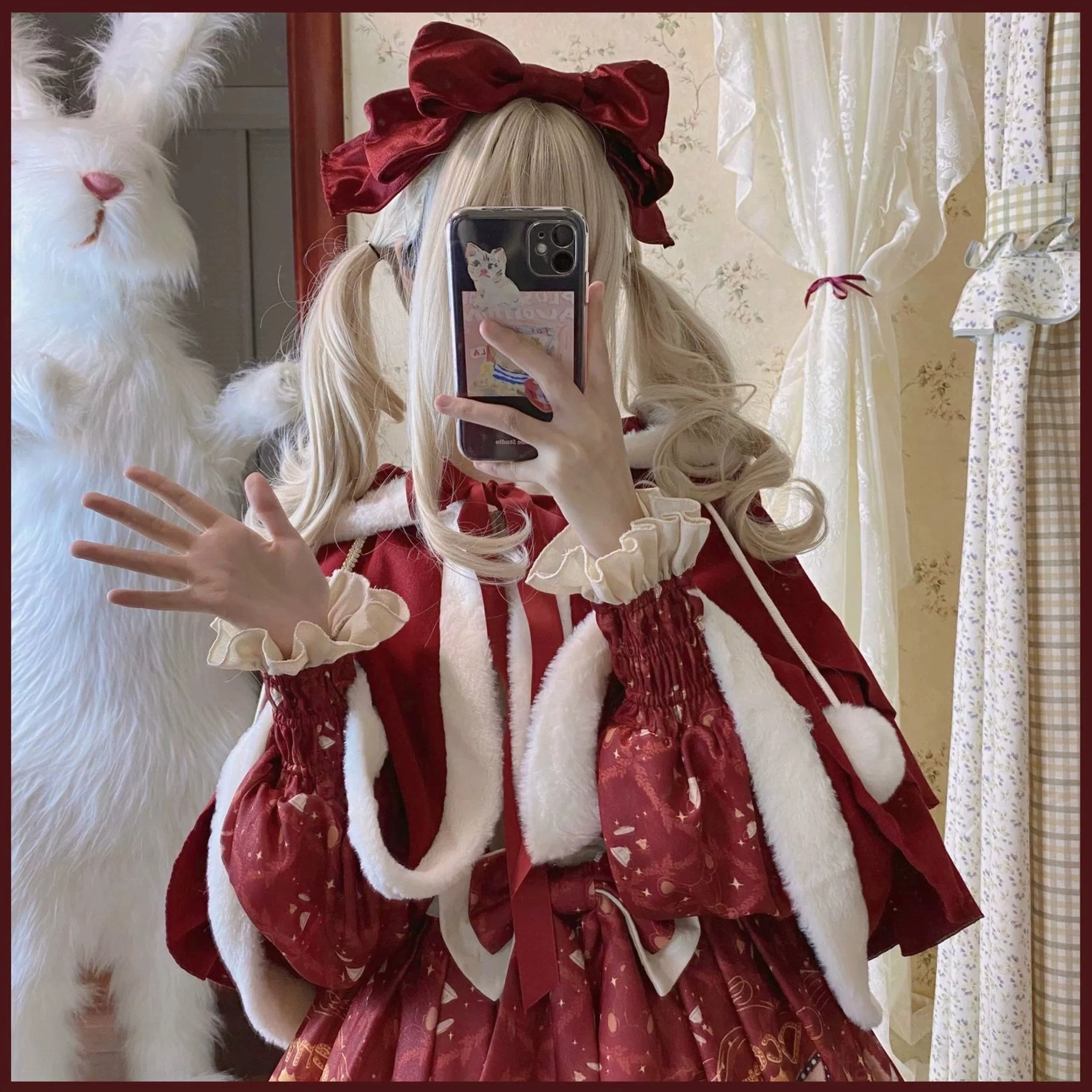 Lolita fur trimmed cape detail close-up showing white plush collar bear ear hood design wine red fabric and front bow decoration on model